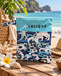 Lalique Ocean Wave swimwear pouch displayed beside the sea